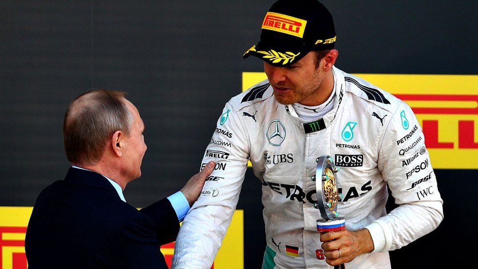 Nico Rosberg of Germany and Mercedes GP collects his winners trophy from Russian President Vladimir Putin during the Formula One Grand Prix of Russia at Sochi Autodrom on May 1, 2016