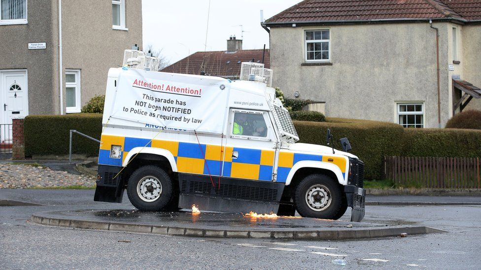 Sign on van reads 'Thsi parade has not been notified to police as required by law'