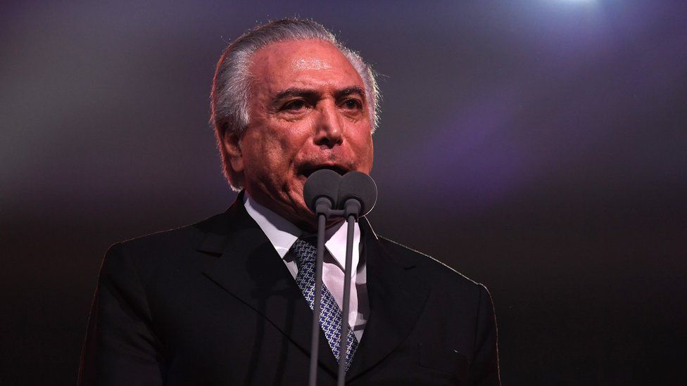 Michel Temer speaks at microphone at opening ceremony