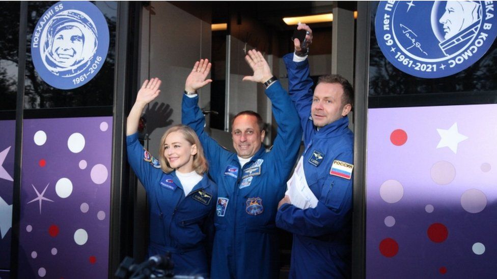 Actress Yulia Peresild, cosmonaut Anton Shkaplerov and film director Klim Shipenko, wave as they attend the send-off ceremony