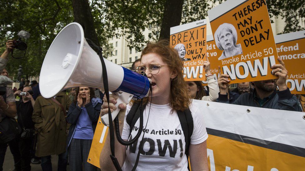 A pro-Brexit demonstrator chants during a protest outside Downing Street