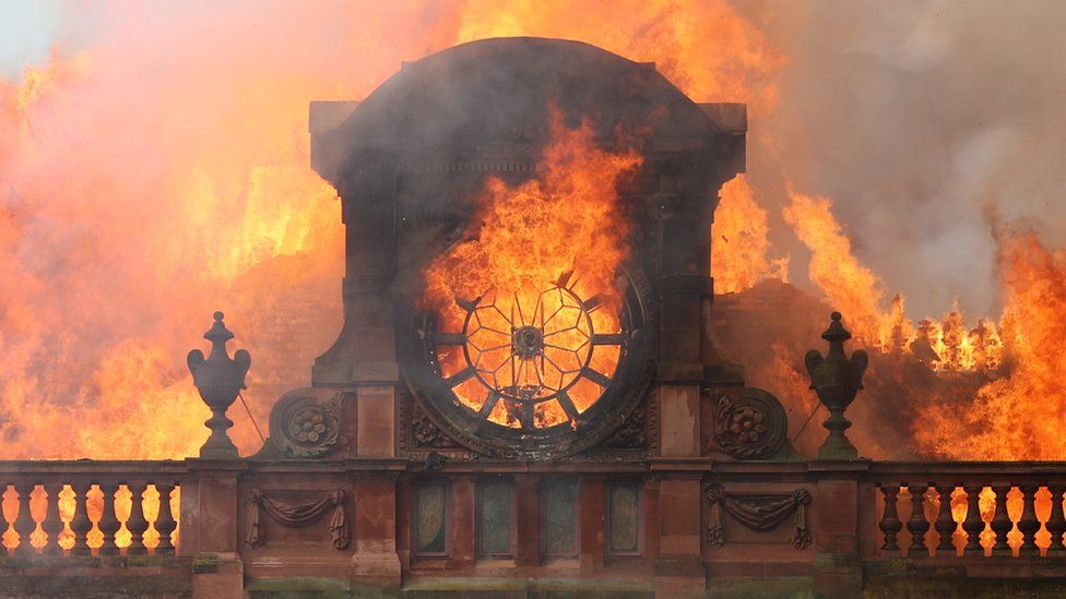 Flames destroy the clock at the top of Bank Buildings in Belfast
