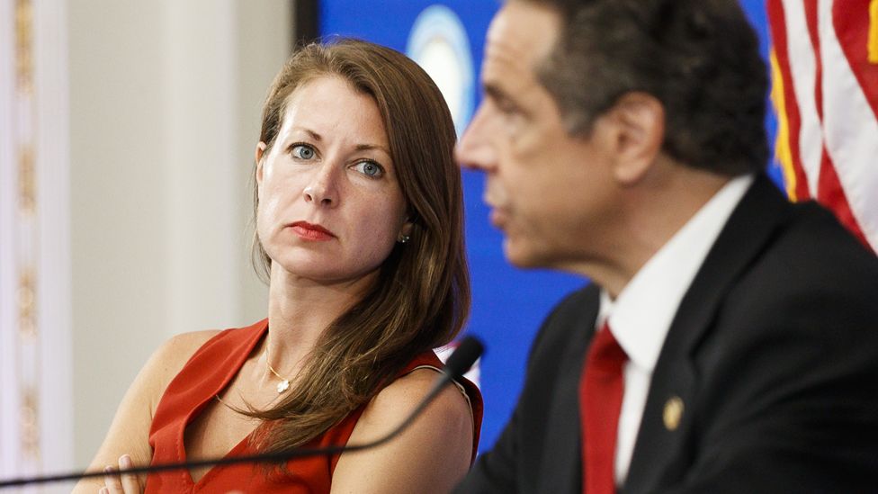 Melissa DeRosa (L), Secretary to New York Governor Andrew Cuomo, listens as Cuomo speaks during his daily briefing in a conference room at the New York Stock Exchange in New York, New York, USA, on 26 May 2020.