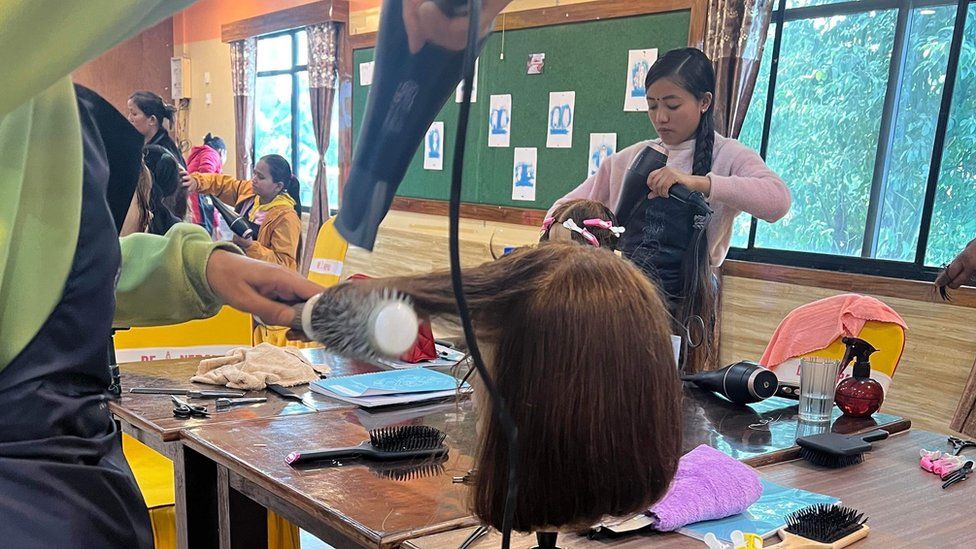 Women practising hairdressing