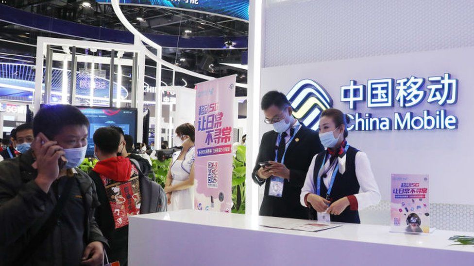 People visit the stand of China Mobile Communications Group.