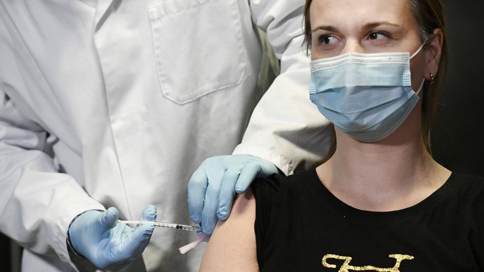 A doctor in the Netherlands receives the Pfizer vaccination