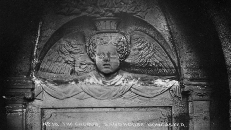 Stone carving of The Cherub sandstone carving