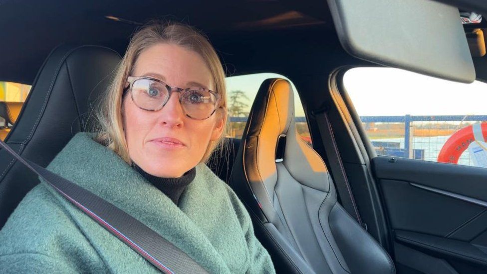 Ann Wall in her car on Reedham Ferry.