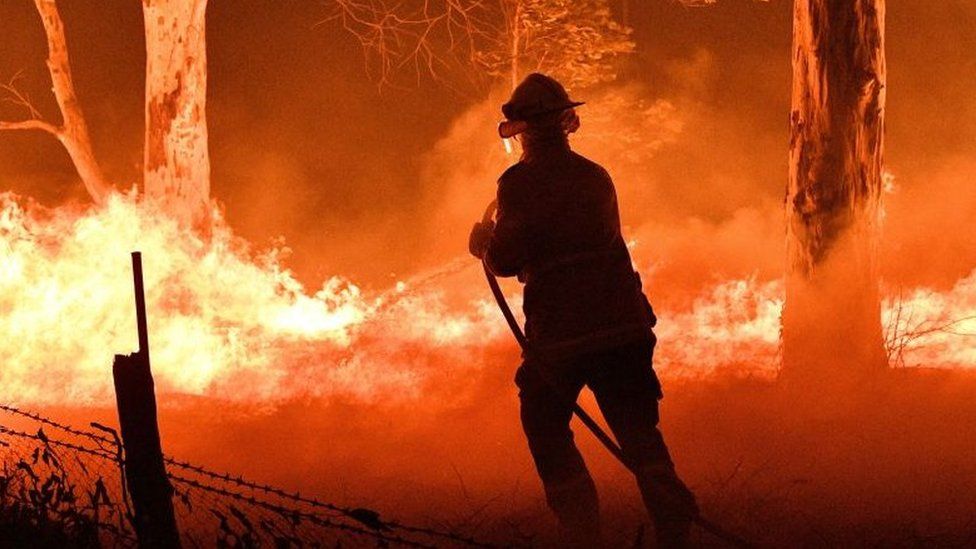 A firefighter tackling a blaze