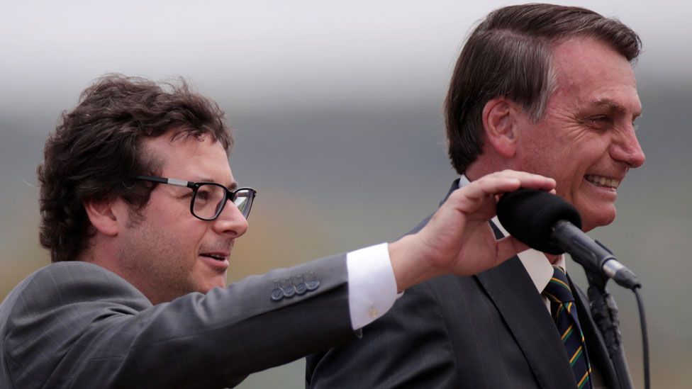 Fabio Wajngarten mutes the microphone for Brazil's President Jair Bolsonaro