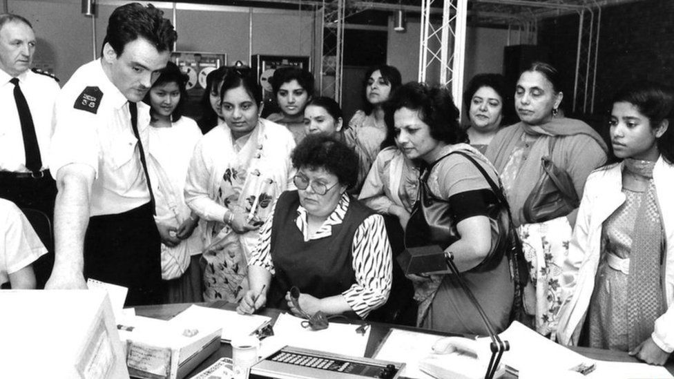 A group of women looking at a police computer
