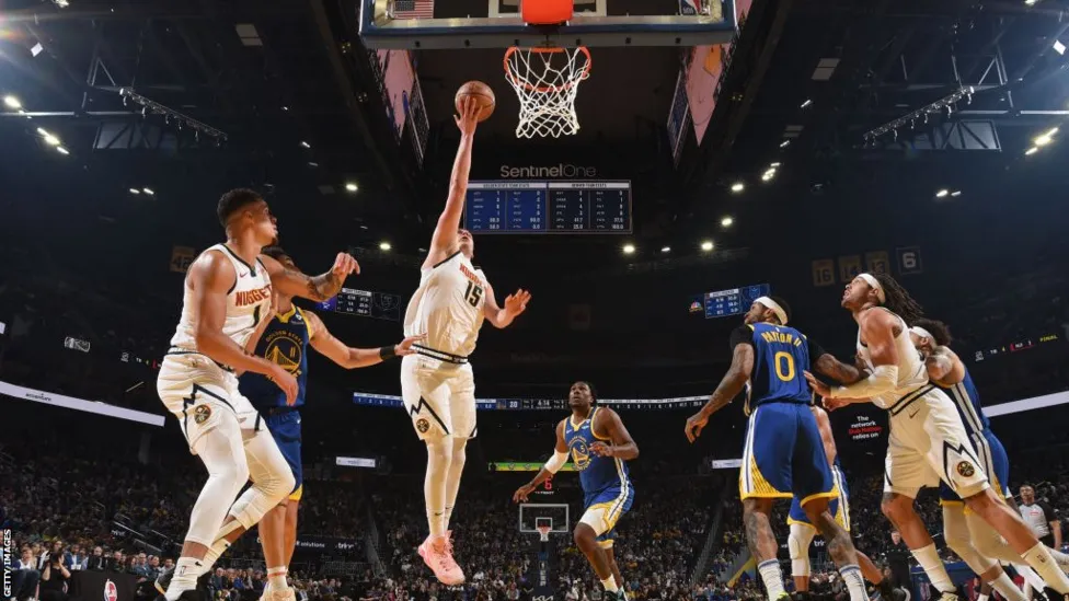 Denver Nuggets Triumph: Nikola Jokic Leads Charge Against Golden State Warriors in NBA Clash.