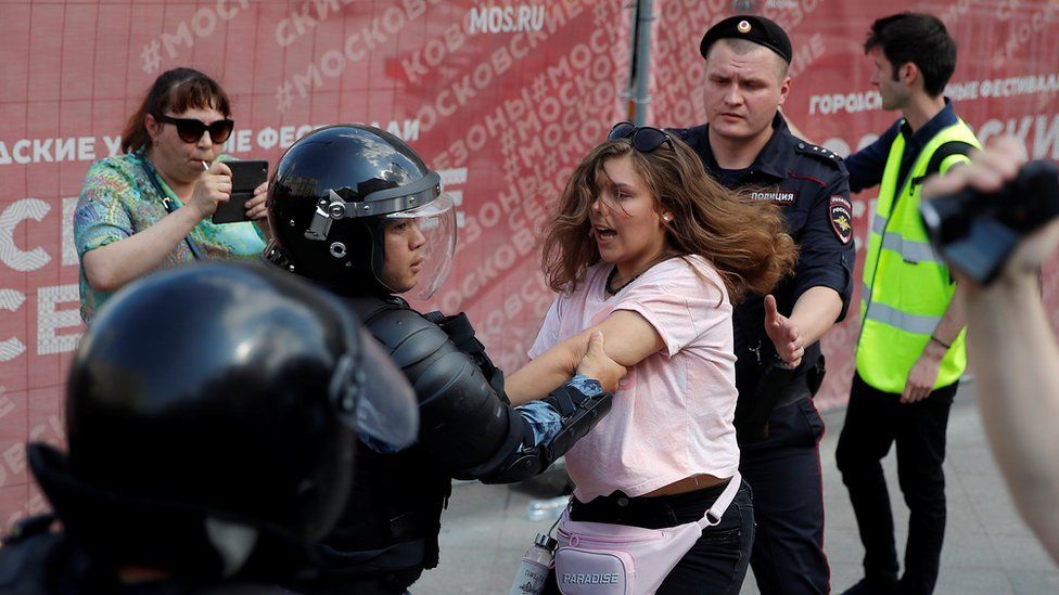 Police detain a protester in Moscow, 27 July