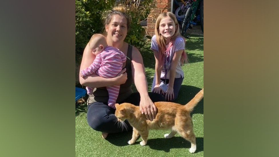 Marney Thompson with her children and cat, Charlie