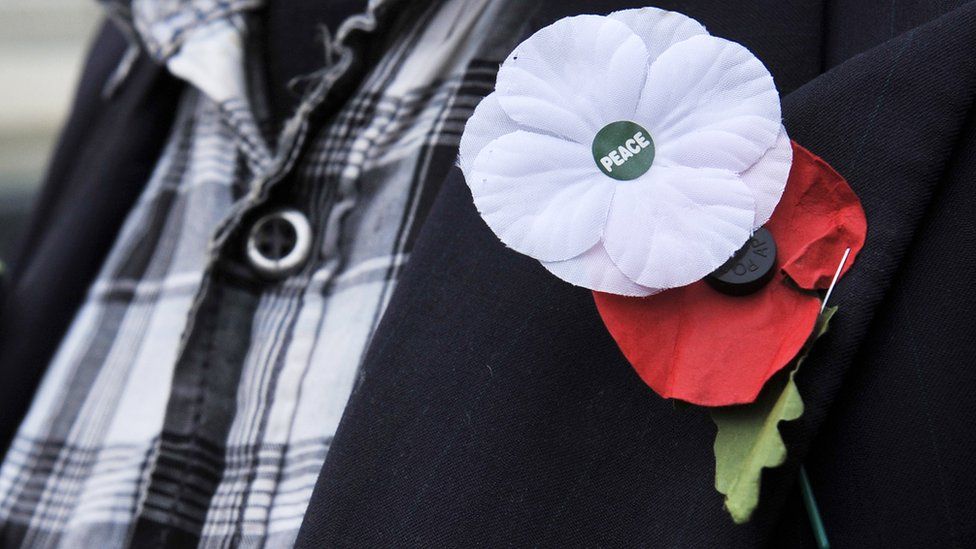 A white and red poppy worn alongside each other