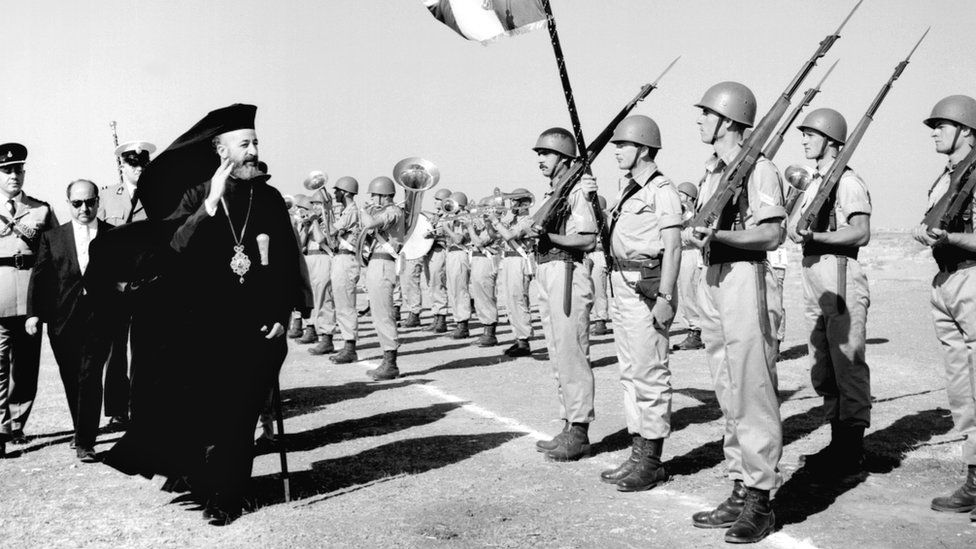 Cyprus President Archbishop Makarios (L, in black hat)reviews troops, September 1960.