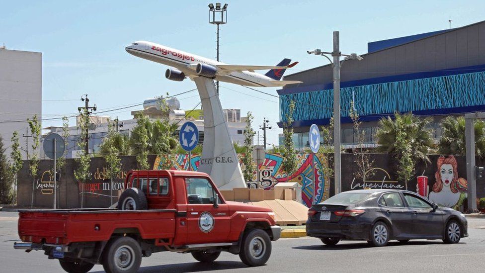 The model of a Zagrosjet passenger plane in the centre of a roundabout, near Irbil's international airport, the day after it was attacked with what the US said was an Iranian-made drone (15 April 2021)