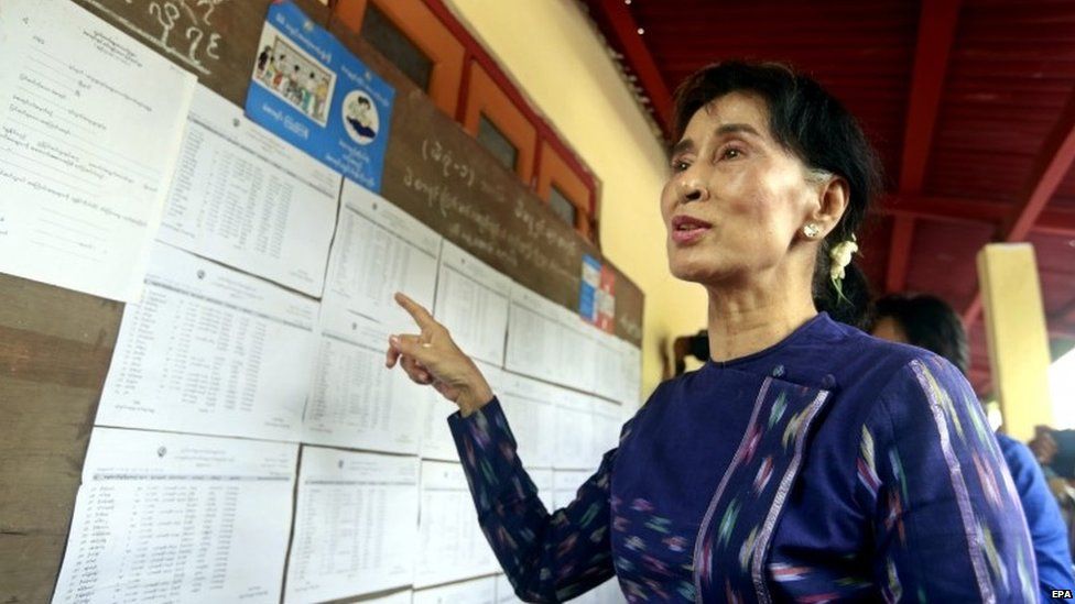 Myanmar opposition leader Aung San Suu Kyi talks to media as she checks the voters list at the Wahtheinkha village in Kawmhu township, Yangon, Myanmar