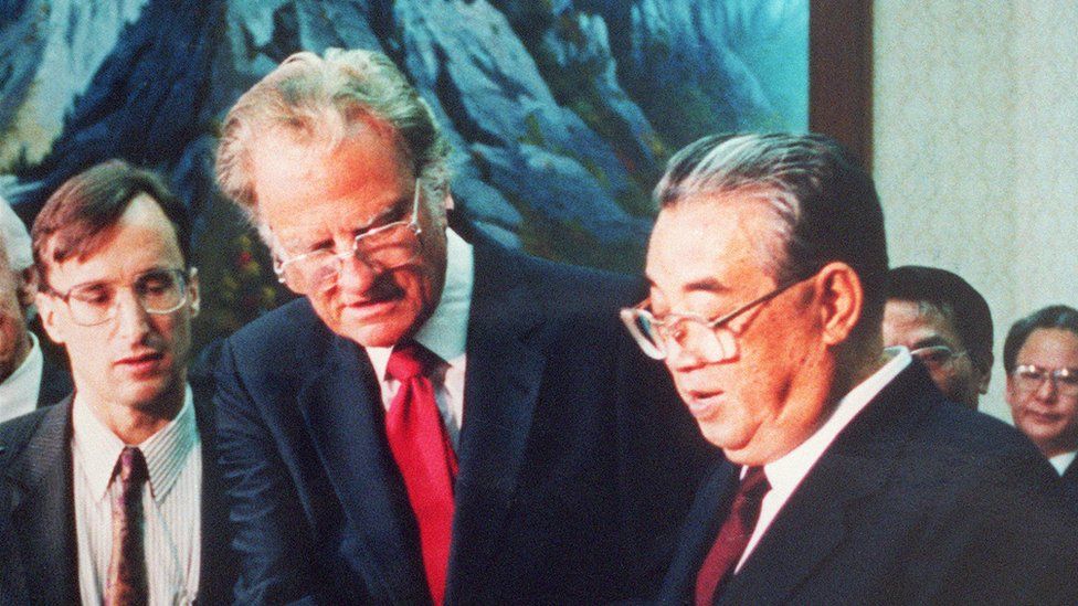 Billy Graham (C), the American evangelist, presents his book 'Peace with God' to North Korean President Kim il-Sung (R) 02 April 1992
