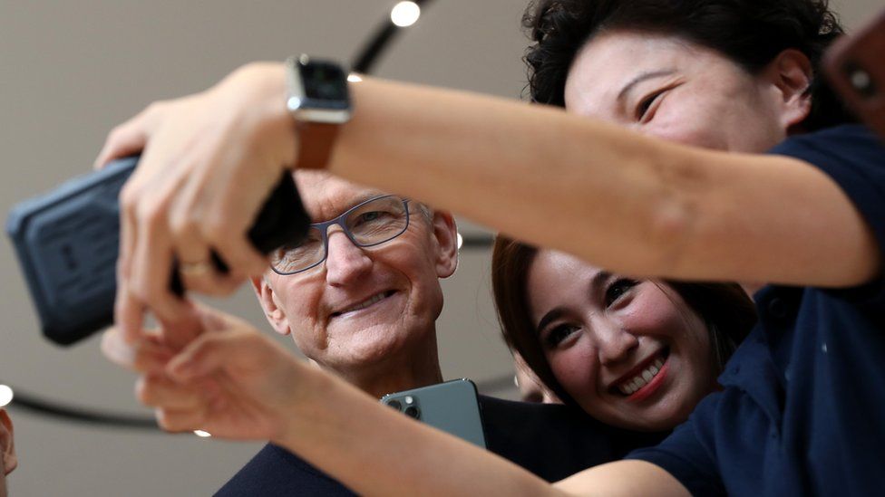 Apple CEO Tim Cook takes a selfie with attendees during an Apple special event on September 10, 2019 in Cupertino, Califo