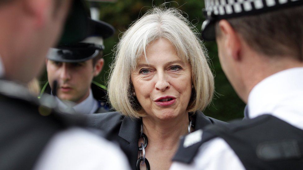 Theresa May speaking with police officers