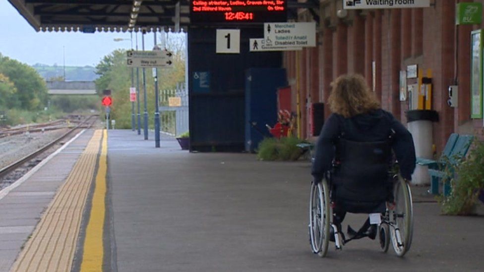 Wheelchair user at a train station