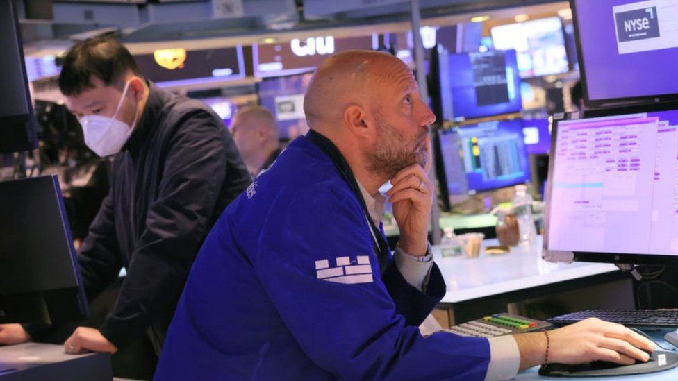 Traders work on the floor of the New York Stock exchange during morning trading in New York City.