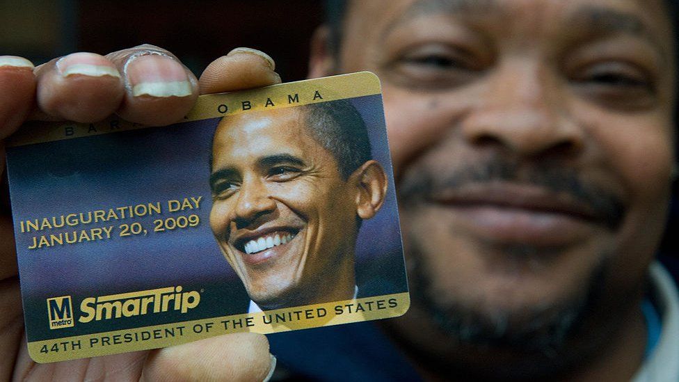 Janitor Fred Thomas shows off his Barack Obama subway fare card in 2009