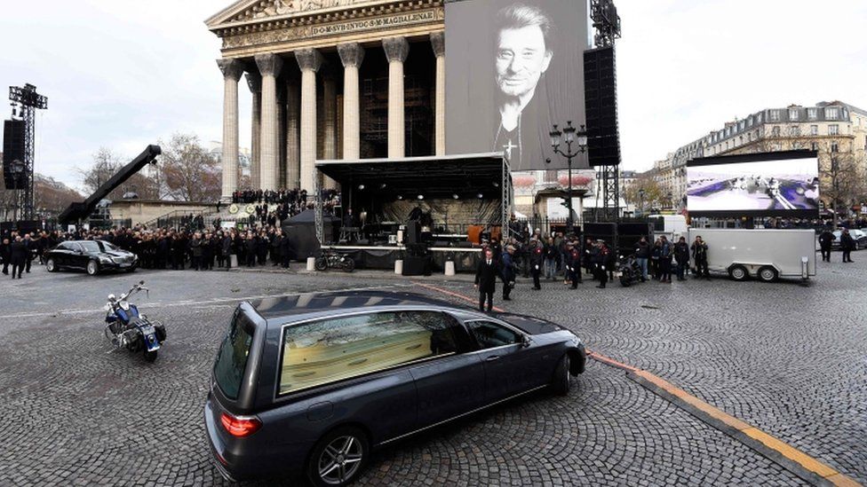 The hearse leaves the Madeleine church in Paris after the funeral ceremony in tribute to late French singer Johnny Hallyday, 9 December 2017