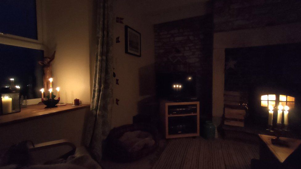 Sitting room lit by candles