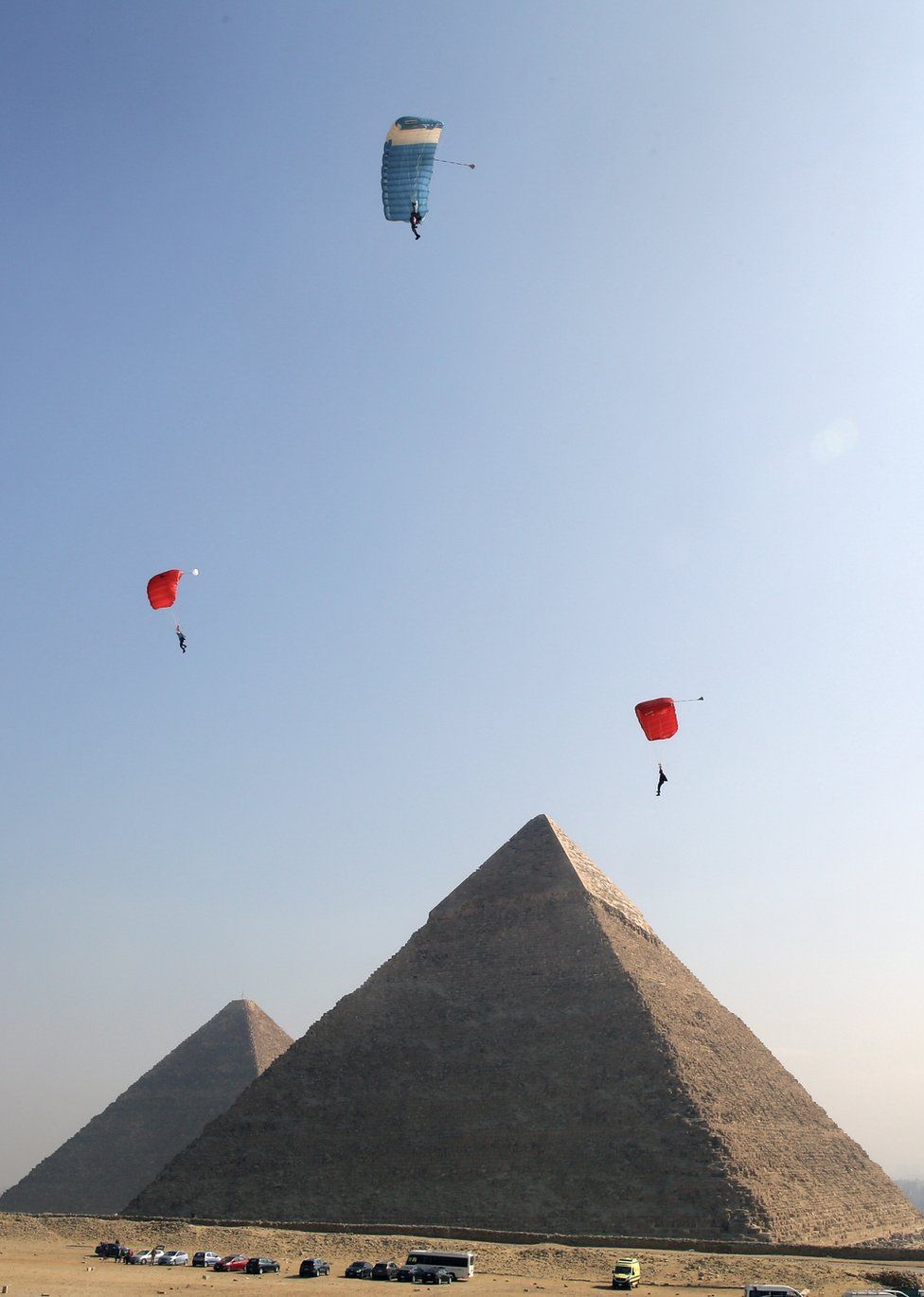 Three powered paragliders take part in the air games festival in front of the Giza pyramid complex, in Giza, Egypt - Monday 19 February 2019