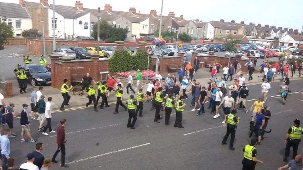 Stand off between police and football fans