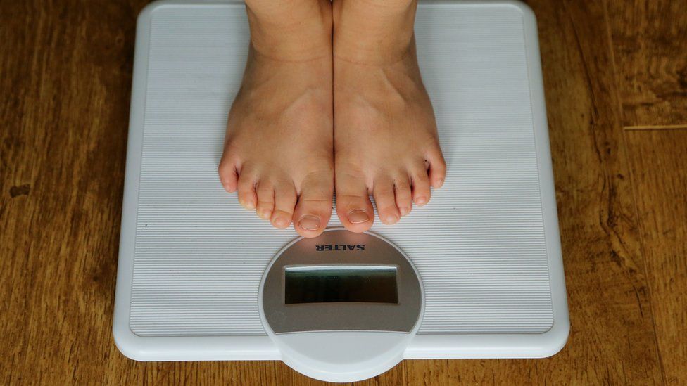 A child being weighed on scales
