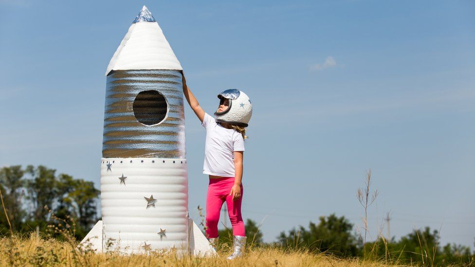 Girl beside a homemade rocket