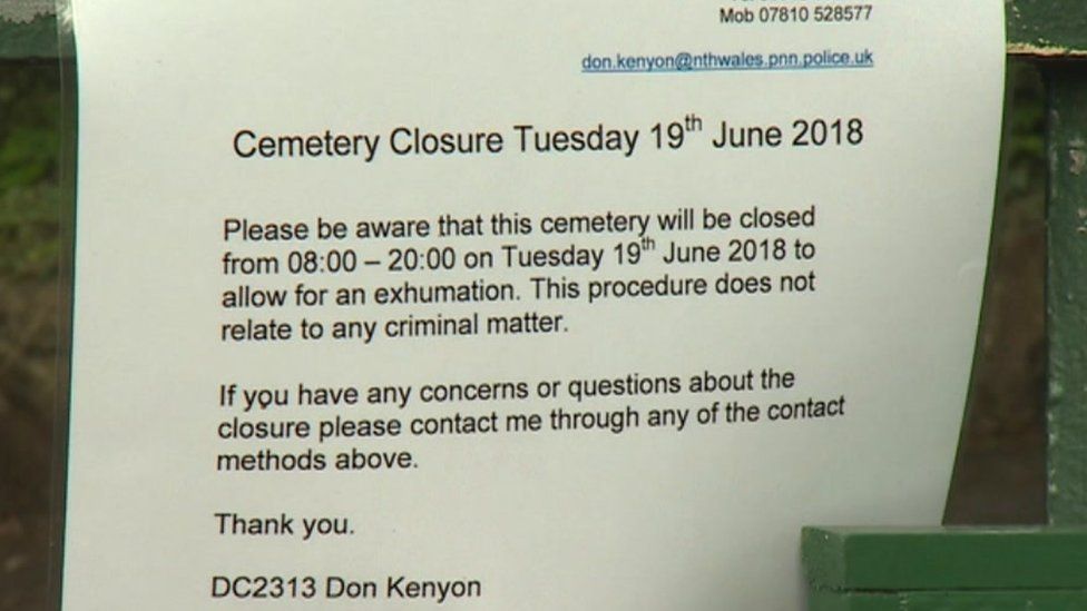 Picture of police notice on cemetery gates