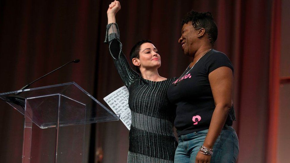 US actress Rose McGowan and Founder of #MeToo Campaign Tarana Burke, embrace on stage at the Women's March / Women's Convention in Detroit, Michigan, on October 27, 2017.