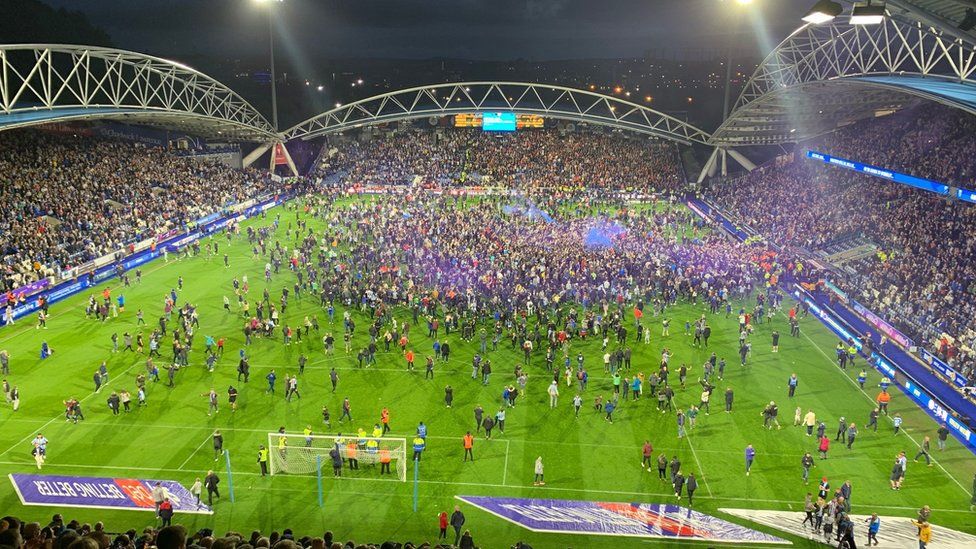 Fans on the pitch at Huddersfield