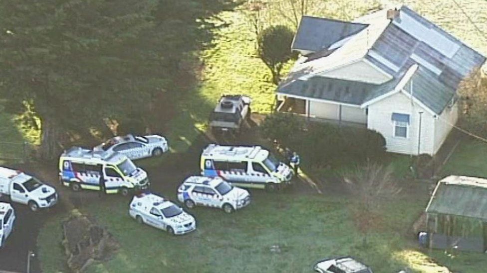 Police and ambulance vehicles outside the house where the dog attack took place
