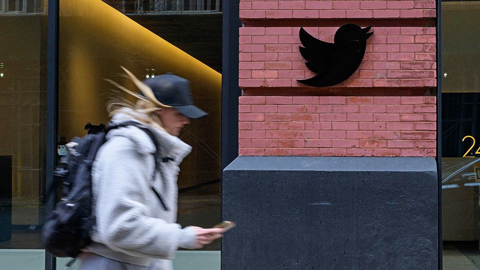 A person walks past the Twitter offices in New York City on January 12, 2023