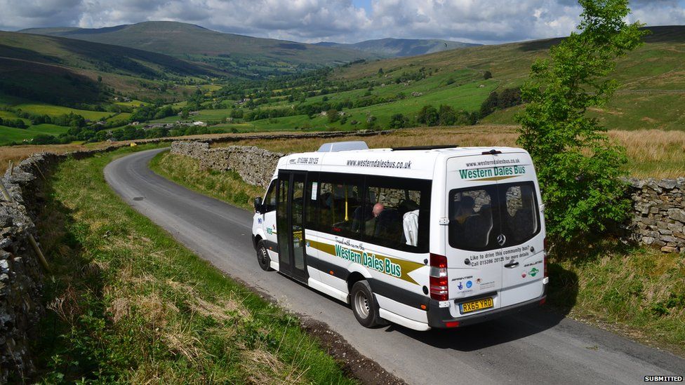 Photo showing a Western Dales Bus driving through countryside