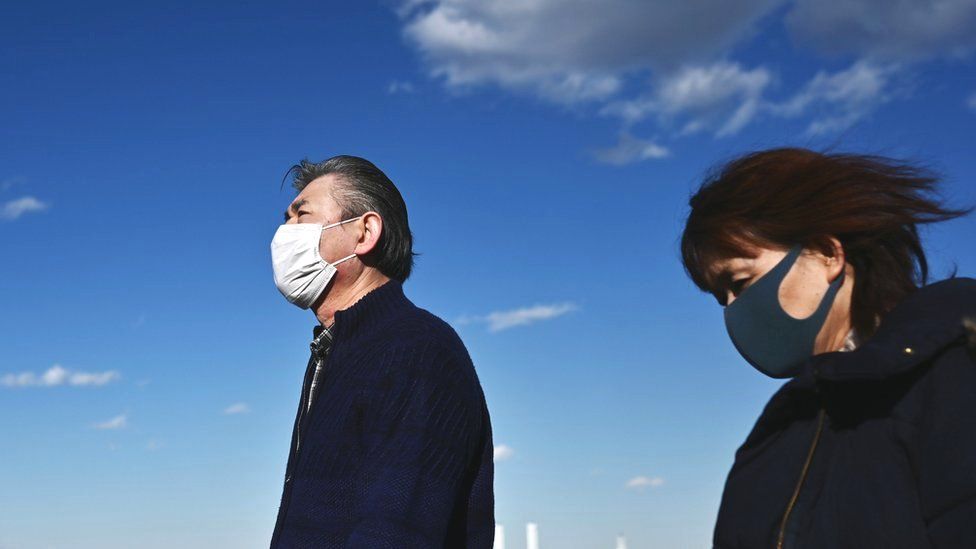 Two people wear facemasks in Yokohama, Japan