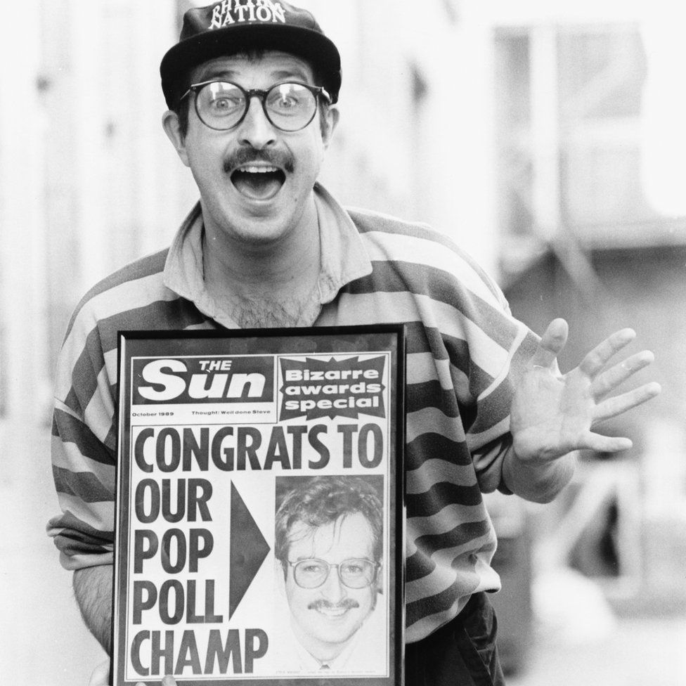 Portrait of BBC Radio 1 disc jockey Steve Wright, posing with a copy of 'The Sun' newspaper which features him on the front page in 1989