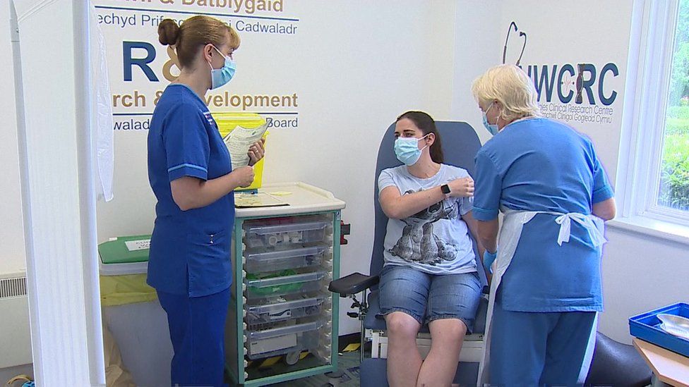 a volunteer is given a Covid booster vaccine at the Wrexham trial