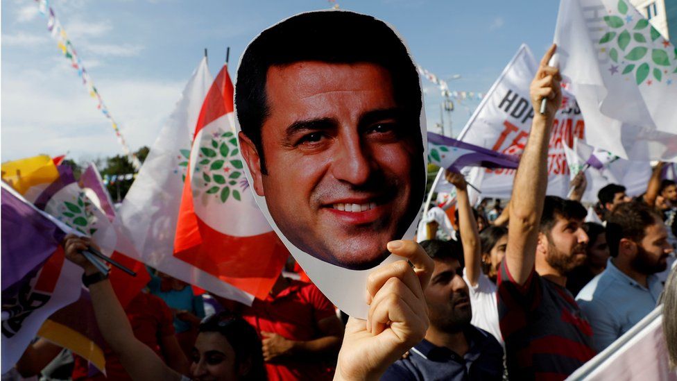 A supporter of the pro-Kurdish Peoples" Democratic Party (HDP) holds a mask of their jailed former leader and presidential candidate Selahattin Demirtas during a rally in Ankara, Turkey, June 19, 2018