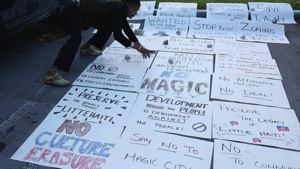 Protest posters against Magic City laid out on the floor