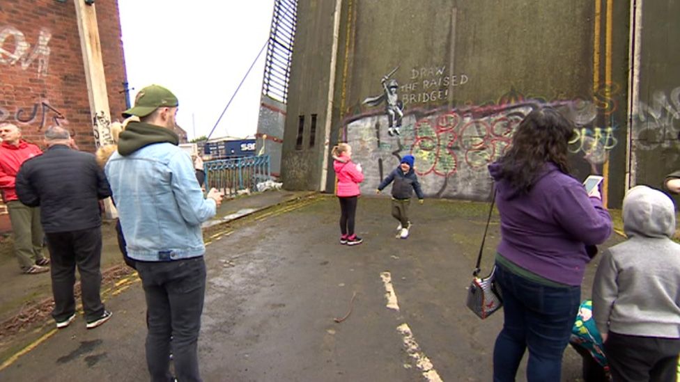 People viewing the Banksy in Hull