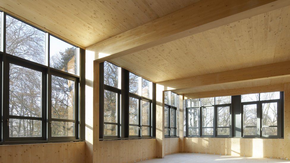 Wooden house interior with large windows