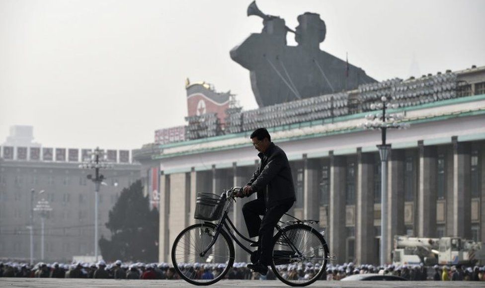 A man rides a bike through Kim Il-sung square in Pyongyang, North Korea (file image)