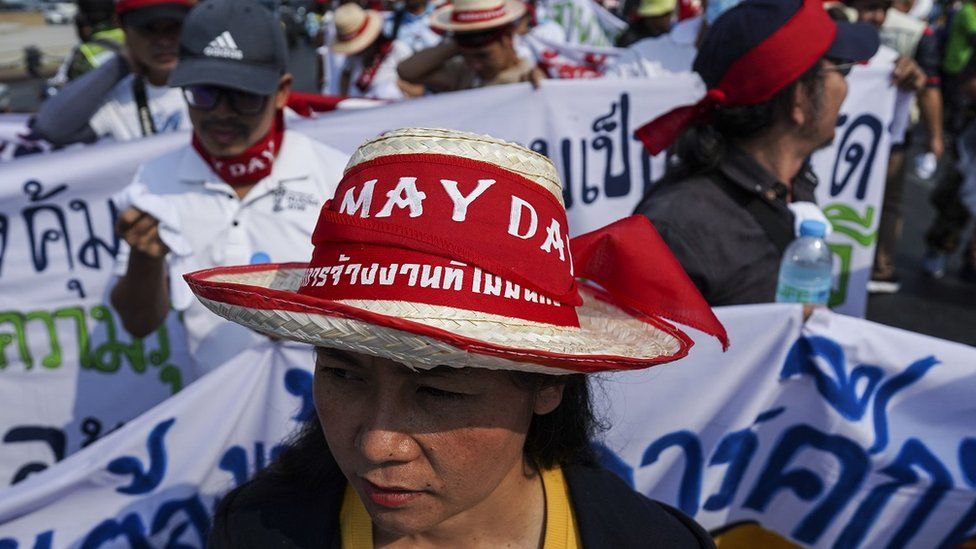Thai workers hold banners as they demonstrate to mark International Workers' Day in Bangkok, Thailand.