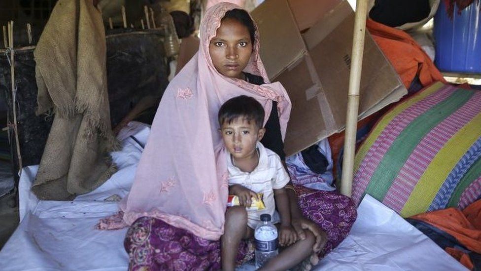 Sabikul Nahar poses for a photo with a kid at a refugee camp in Cox's Bazar, Bangladesh on December 19, 2017